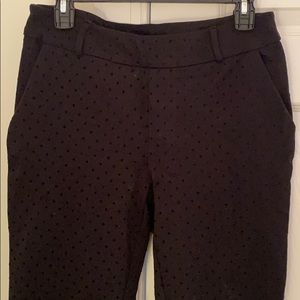 Black stretch pants with velvet black polka dots